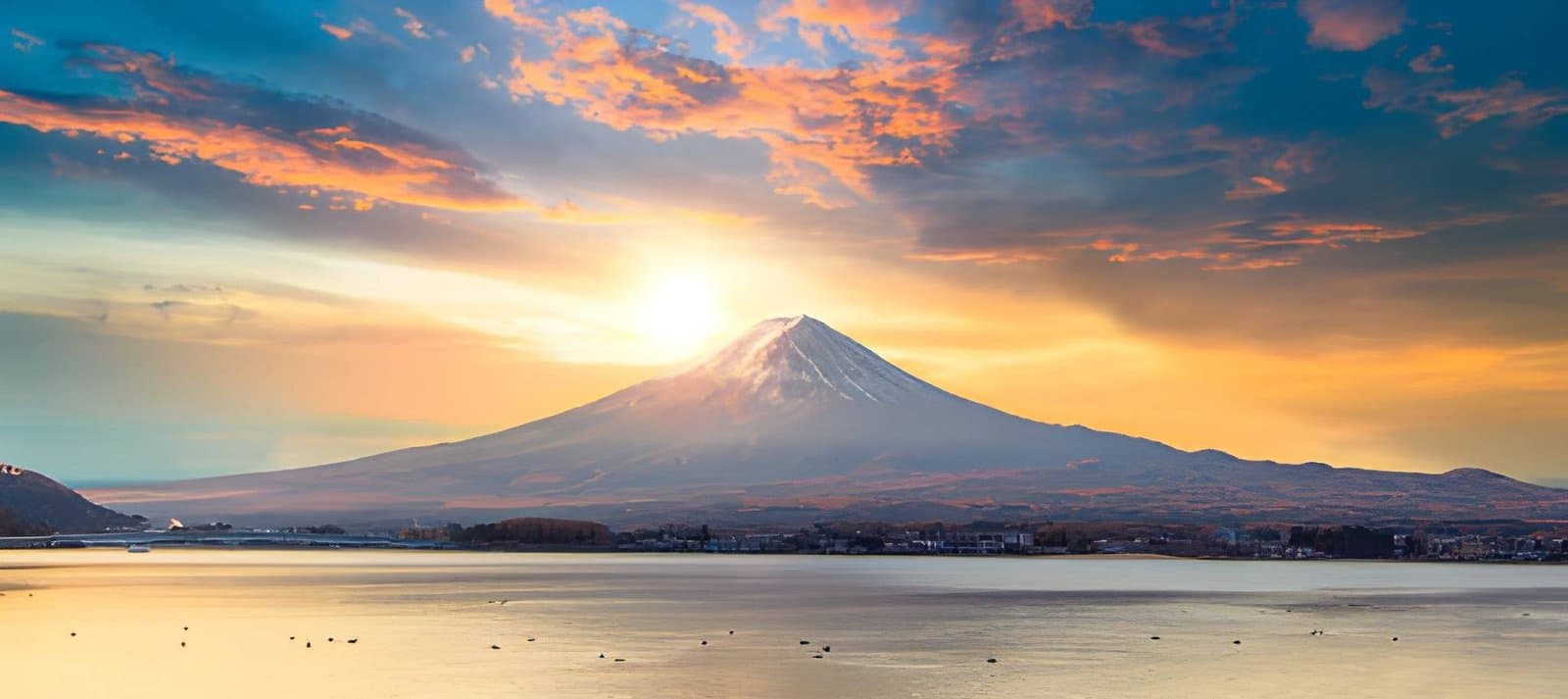 Sunrise over Mt. Fuji viewed from a serene lake Japan